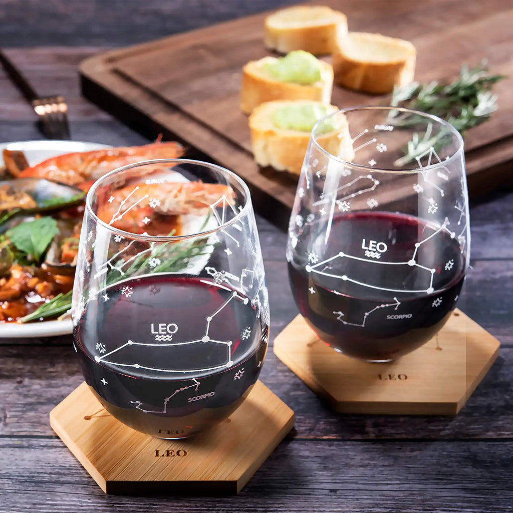 Set of 2 Zodiac Sign Wine Glasses with 2 Wooden Coasters by The Wine Savant - Astrology Drinking Glass Set with Etched Constellation Tumblers for Juice, Water Home Bar Horoscope Gifts 18oz (Leo)